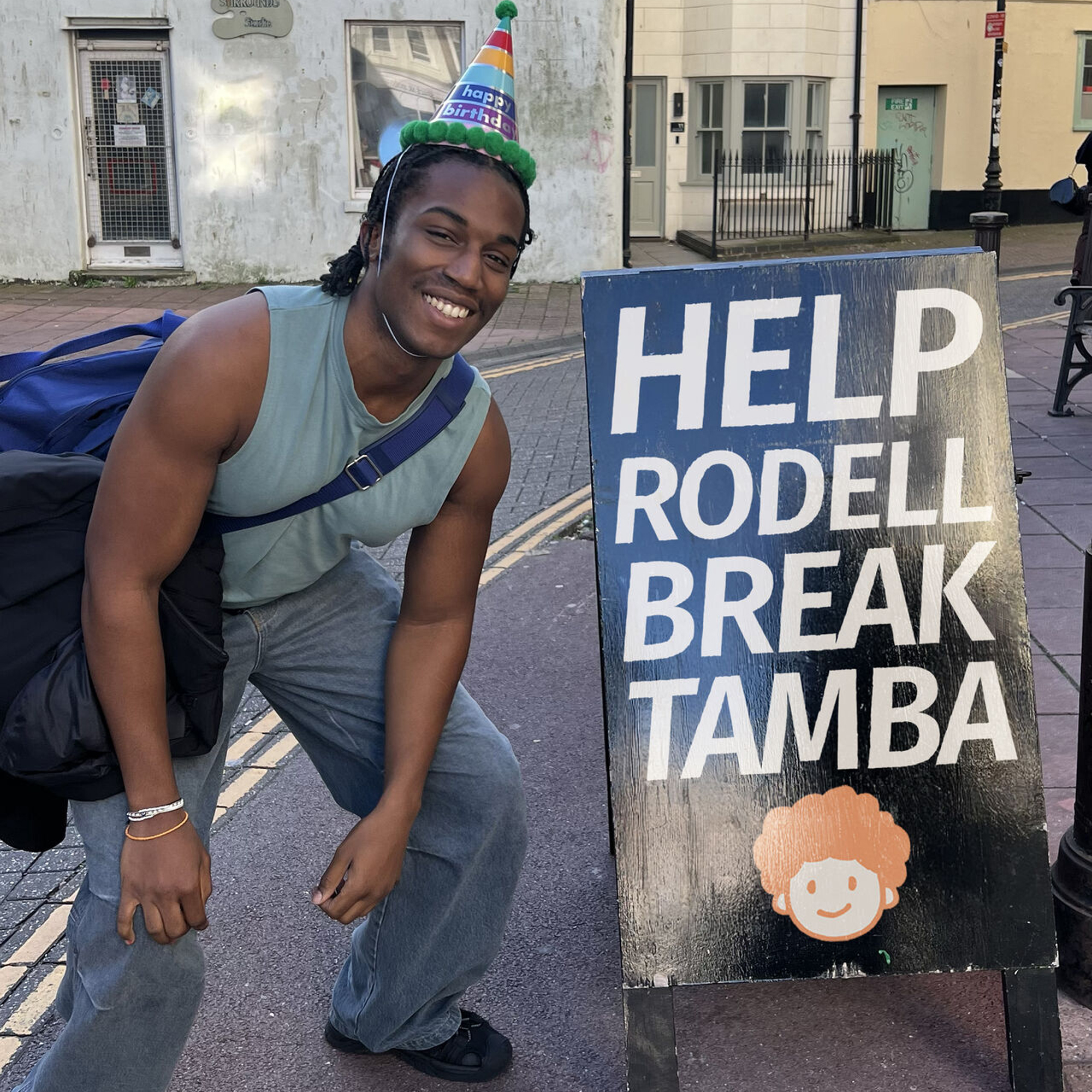 Rodell next to the Help Rodell Break TAMBA sign